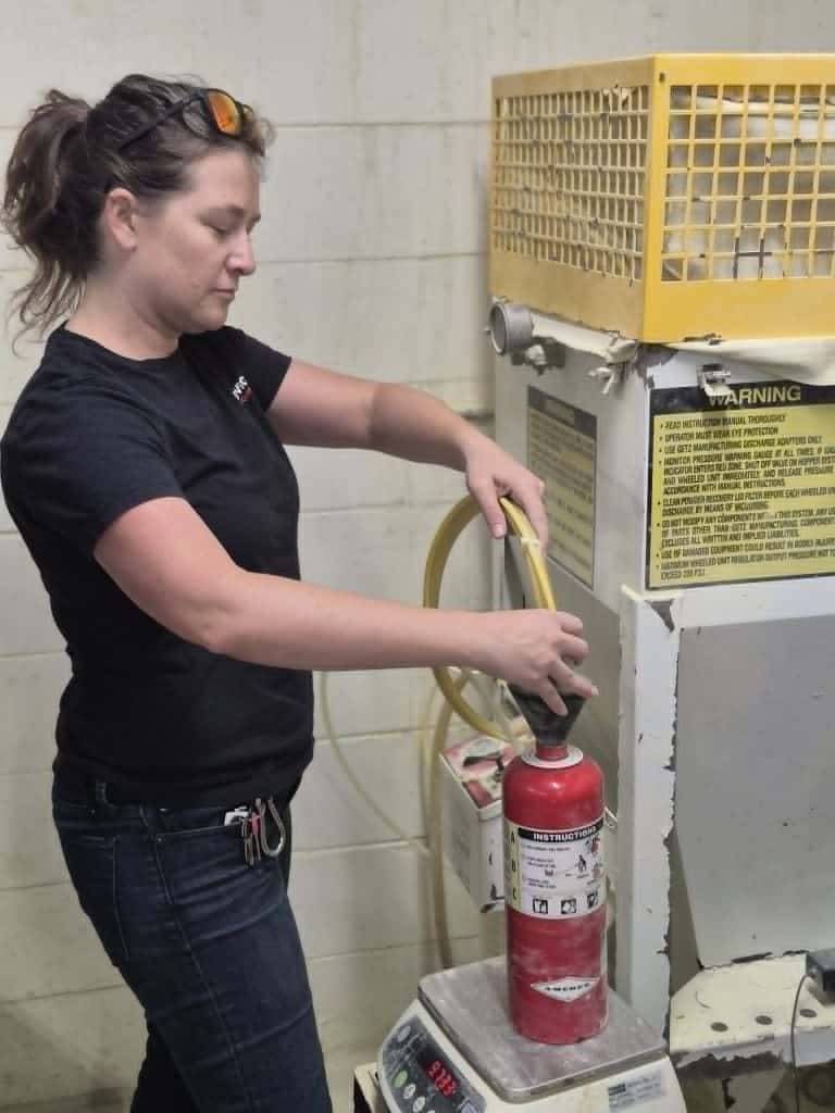 Hailey refilling a fire extinguisher at Serviced Fire Equipment, St. Petersburg, FL