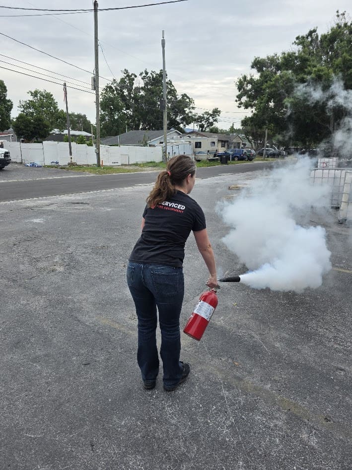 Proper fire extinguisher discharge technique - PASS method demonstrated at Serviced Fire Equipment