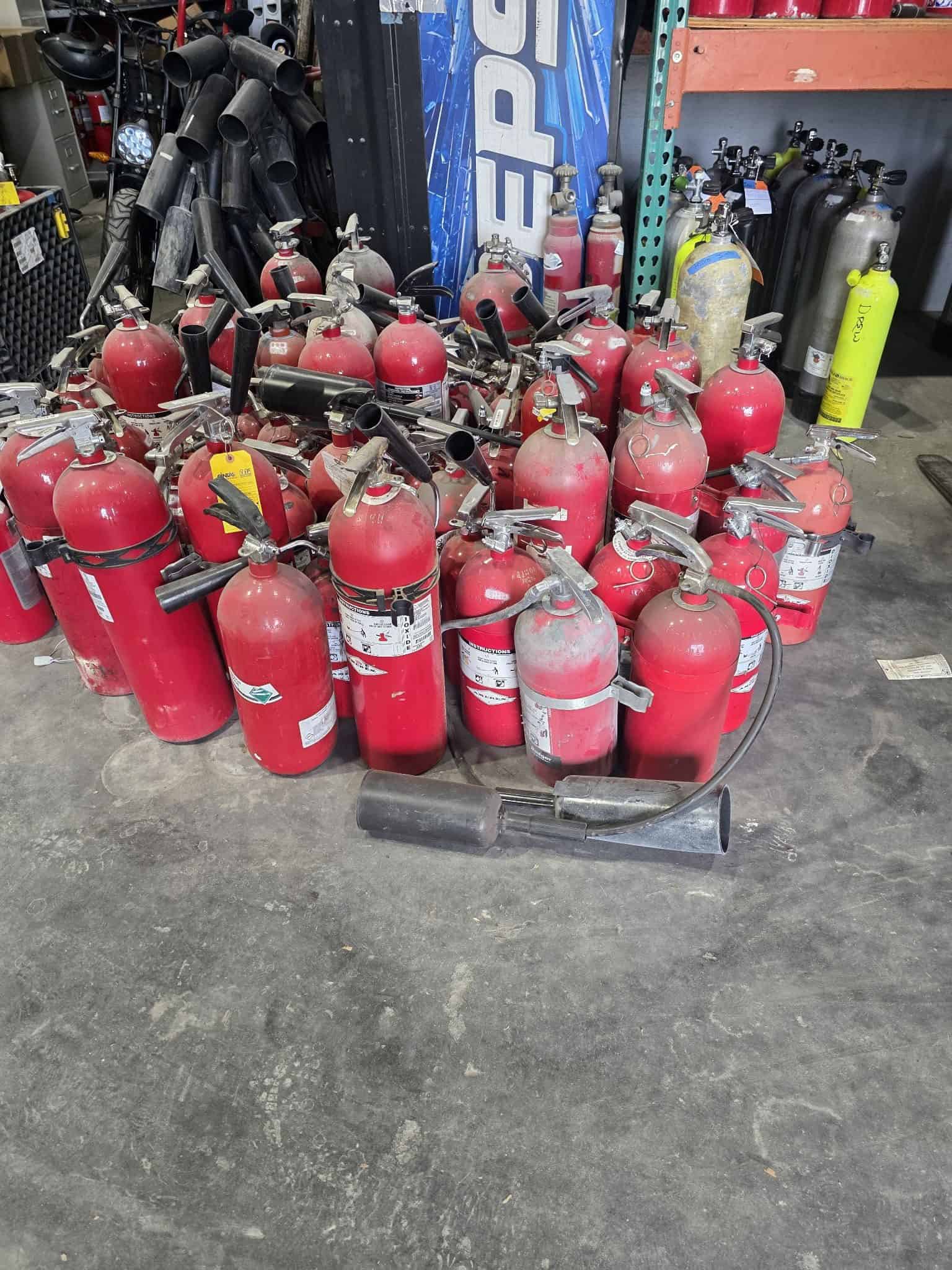 Two large containers full of fire extinguishers awaiting disposal at the Serviced Fire Equipment facility in St. Petersburg, FL