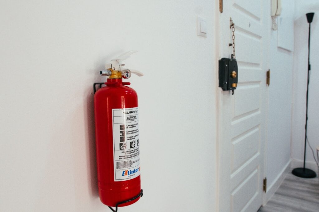 Halotron Fire Extinguisher Mounted on Wall Near Exit Door